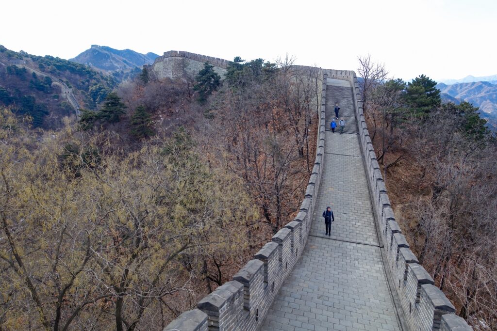 万里の長城の急な階段と険しい登り道を歩く観光客